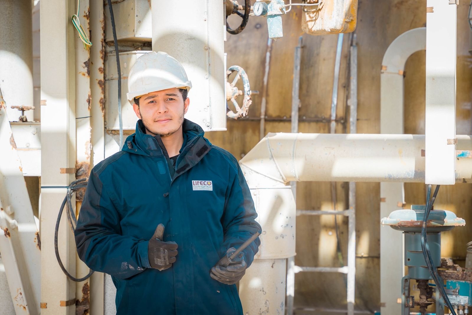 Engineer in safety gear at an industrial plant