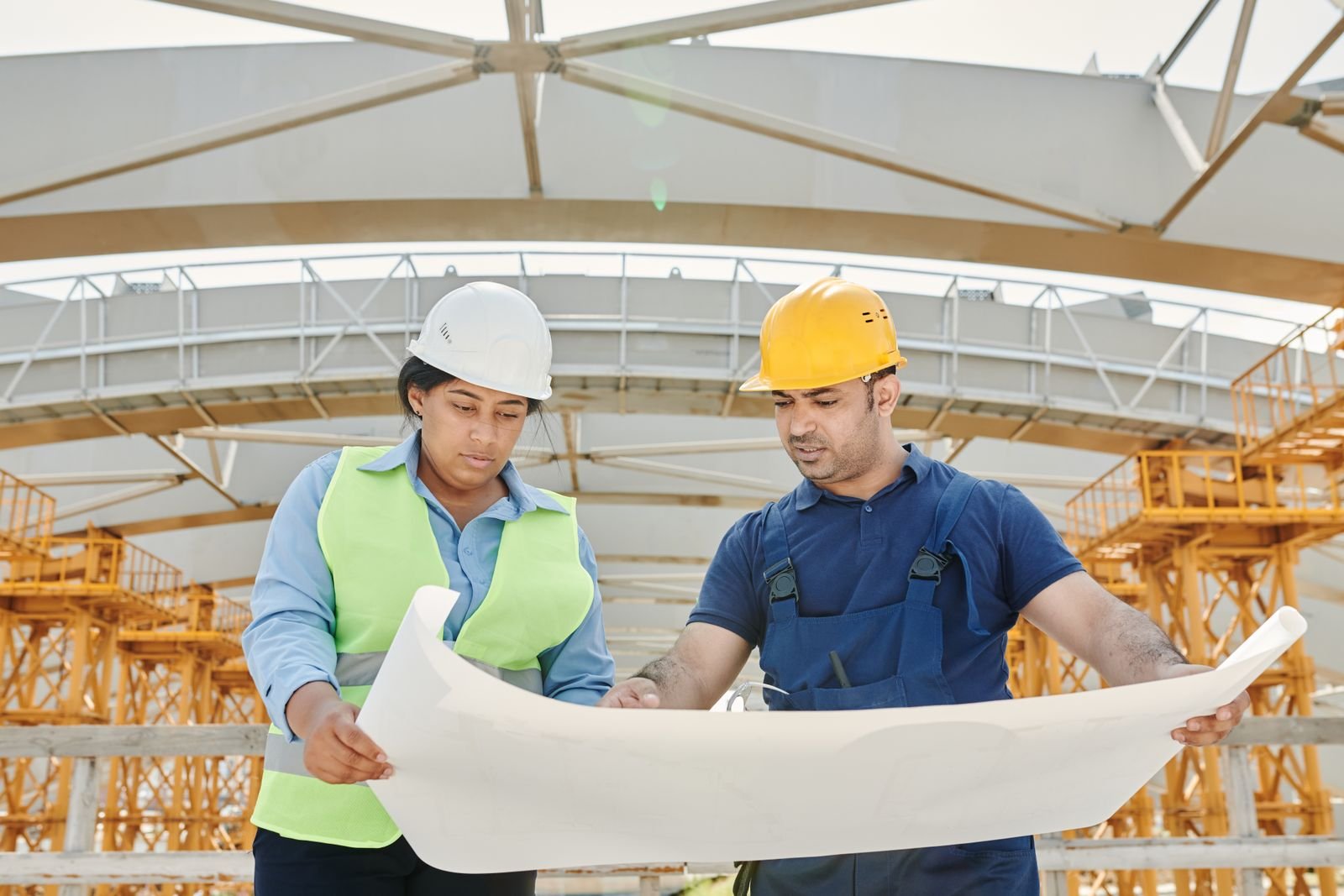 Engineers discussing plans at a construction site
