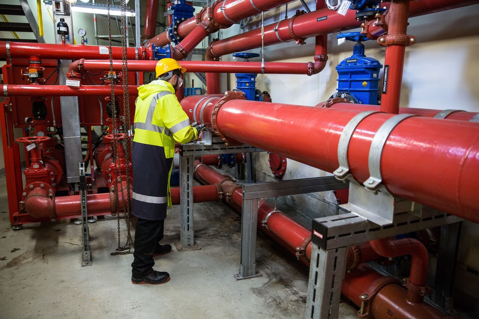 Engineer inspecting an industrial piping system